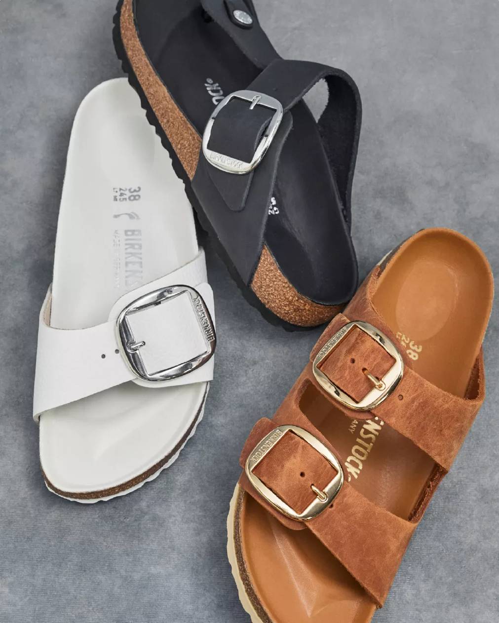 Three platform sandals on a grey background