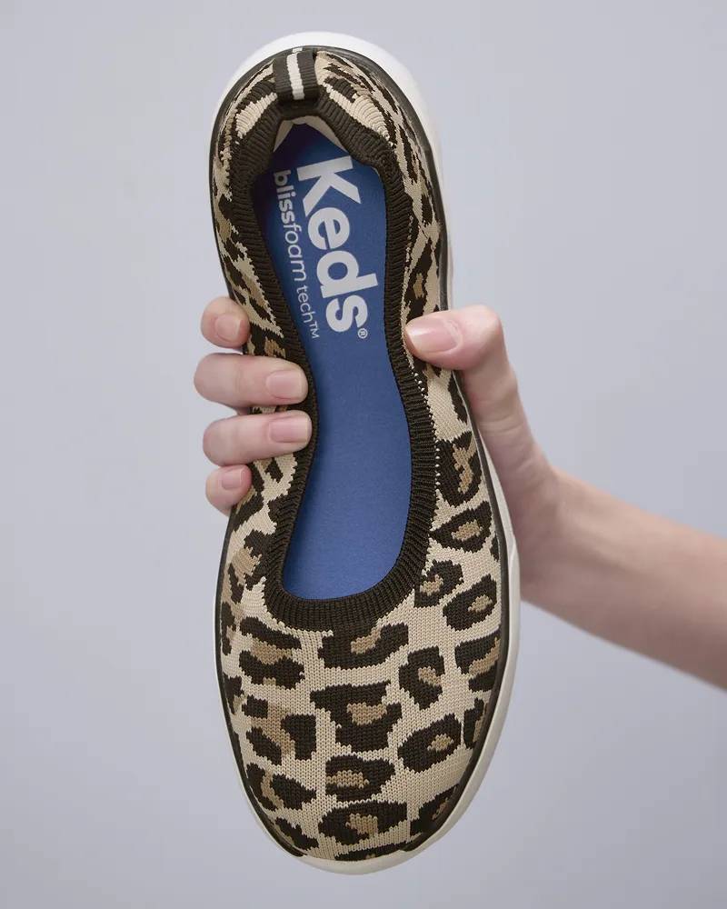 A woman is holding the Blisswalk Skimmer in leopard knit. Shop Skimmers.