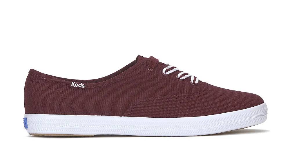 A side view of the Keds Champion Canvas Lace-Up in burgundy.