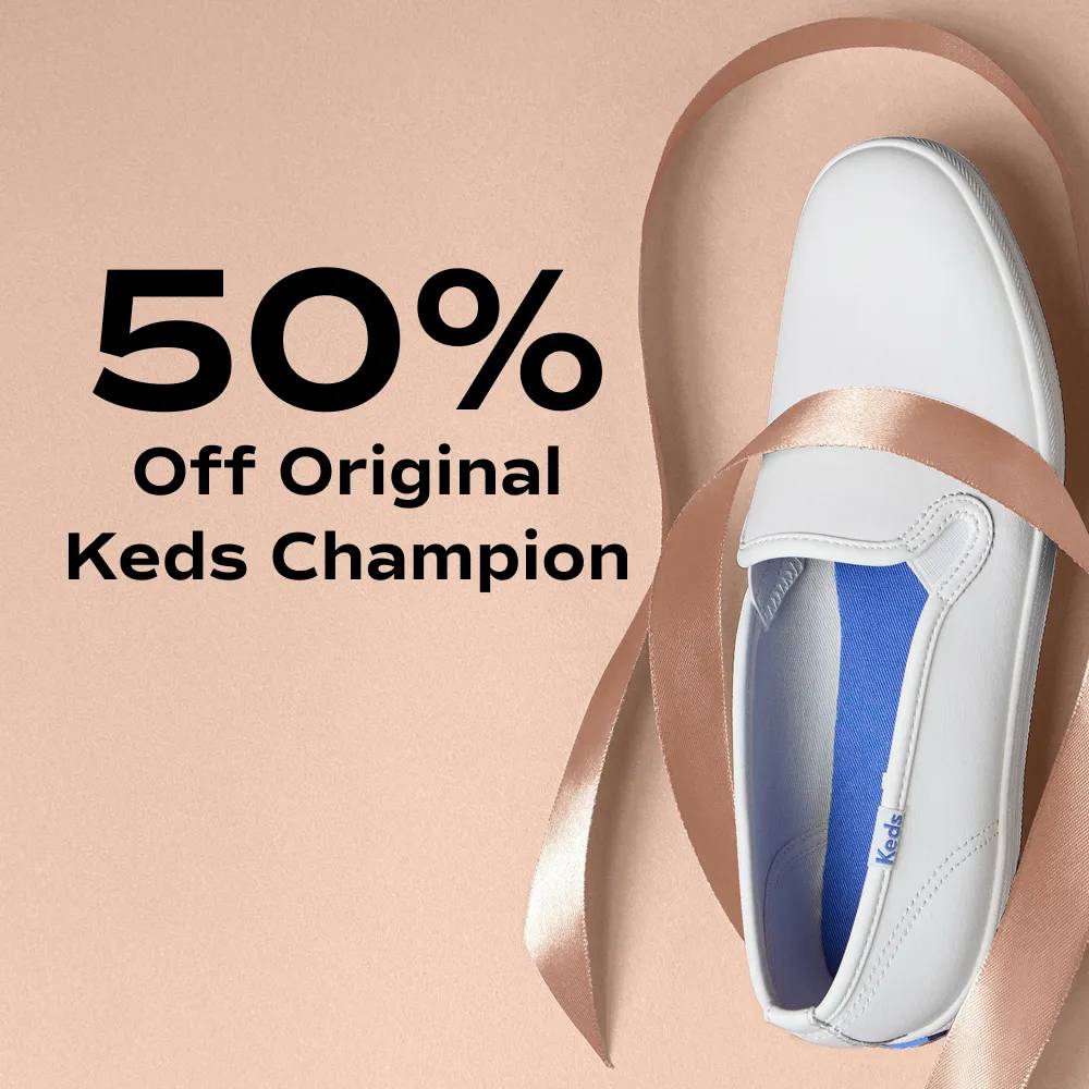 A pink background with the Keds Champion Leather Slip-On in white pointing up and draped with a strand of red ribbon. The text says 50% Off Original Keds Champion