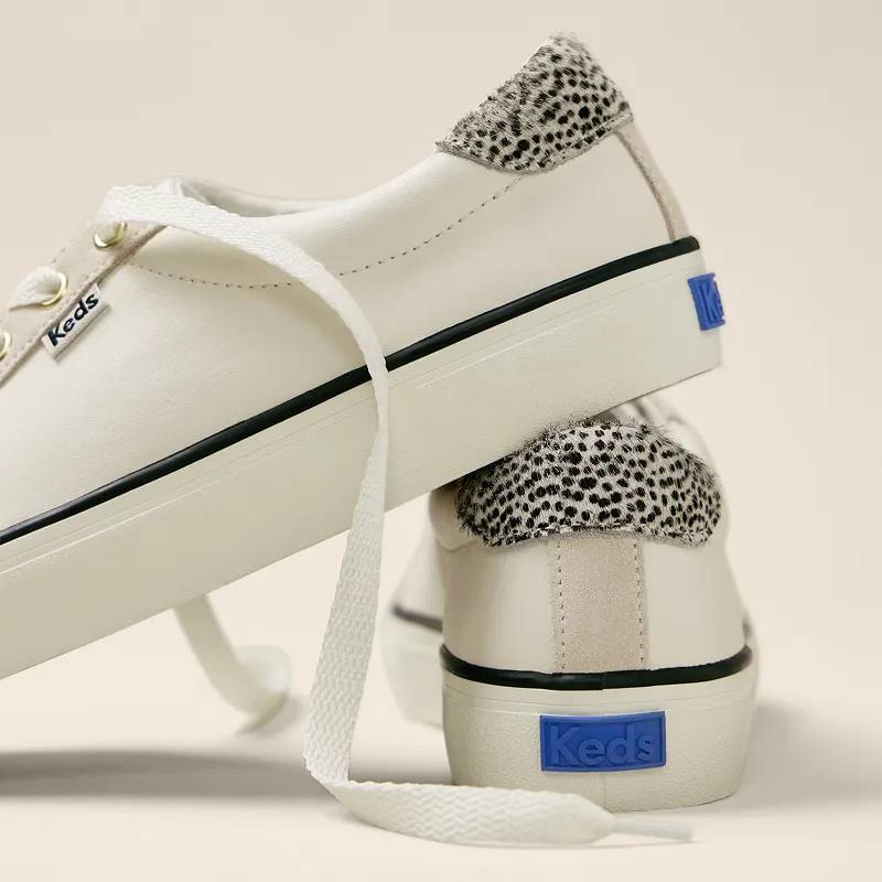 A closeup on the back of the Jump Kick T-Toe Leather/Suede Hair Calf Heel Lace-Ups showcasing the sneaker’s contrasting heel tab. Text under the image says Retro. Vintage looks, modern comfort. Shop Now.