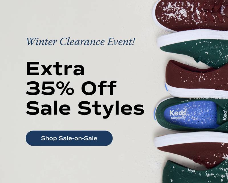 Multiple pairs of the Keds Champion Canvas Lace-Ups lined up in a vertical row on the right side. The sneakers interchange colors—burgundy and forest green—and are sprinkled with a light dusting of snow. Text to the left of the sneakers says Winter Clearance Event! Extra 35% Off Sale Styles. Shop Sale-on-Sale.