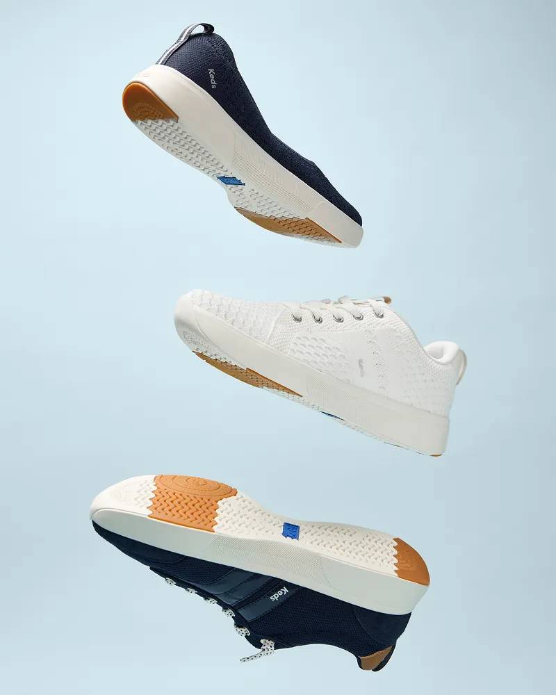 Three BlissWalk styles—the loafer, the lace-up, and the Ubal—shown floating in the air against a light blue background to demonstrate the sneaker’s ultra lightweight design. Text under the image says Super Lightweight. Light-as-air ease and flexibility.