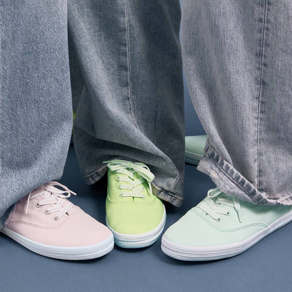 Three women in wide-leg denim and the Keds Champion in exclusive pastel colors.