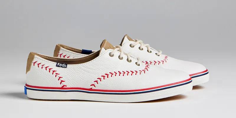 A side view of a pair of Keds Champion Leather Pennant Lace-Ups in off white. Shop Leather Keds Champion Styles.