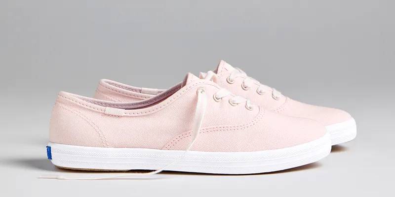 A side view of a pair of Keds Champion Canvas Lace-Ups in icy pink. Shop Seasonal Keds Champion Styles.