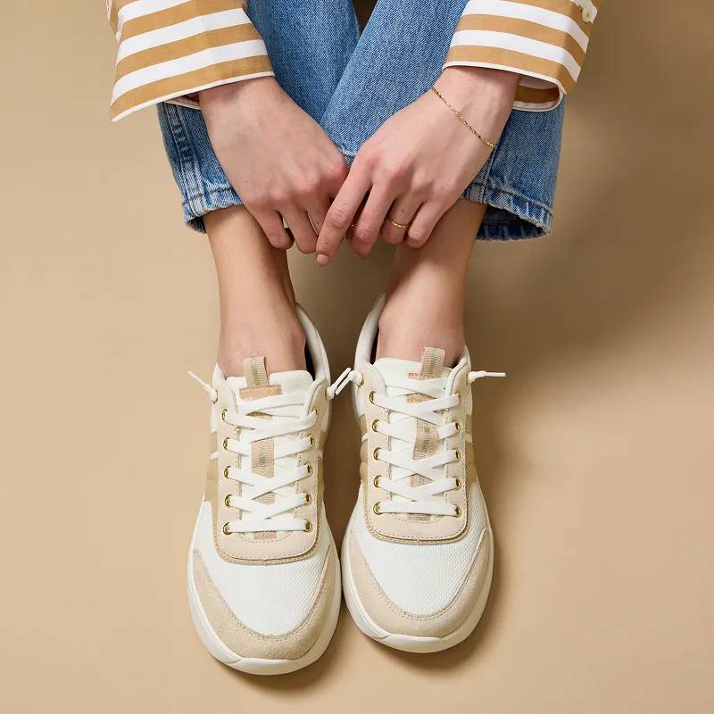 The mesh/suede/leather BlissWalk Ubal in egret/Cuban sand shown on foot paired with classic straight-leg jeans and a white-and-beige striped long-sleeved T-shirt.