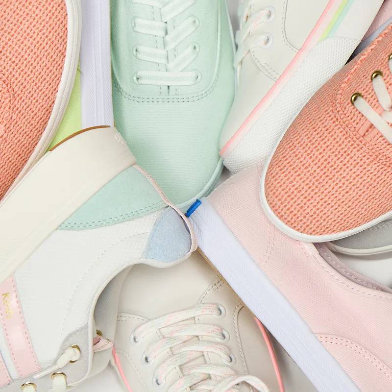 A group of different sneaker styles in various shades of pastels.