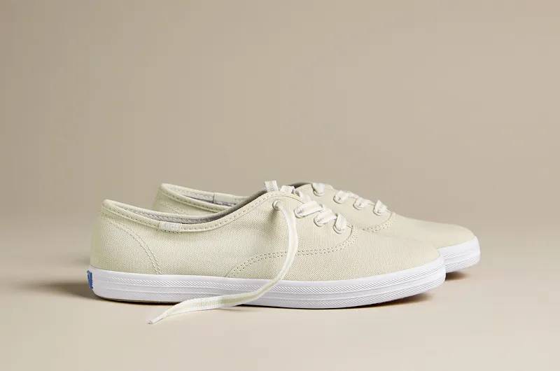 A side view of the Keds Champion Leather Lace-Up in oatmeal. Shop Lace-Ups.