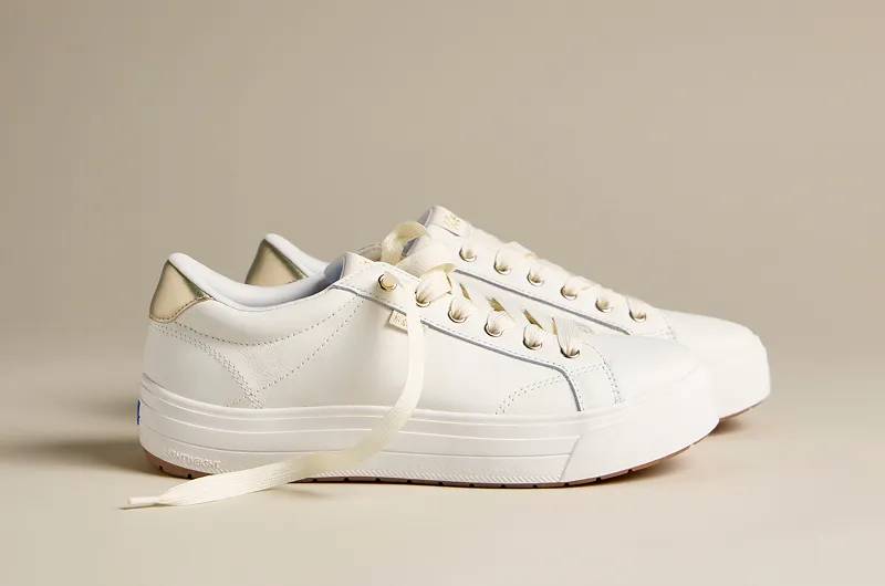 A side view of the Park Slip-On Leather in snow white/champagne. Shop Boots.