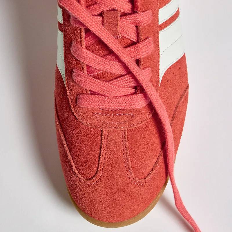 An overhead view of the front of the Revival Suede/Leather Lace-Up in orange/snow white facing opposite directions.