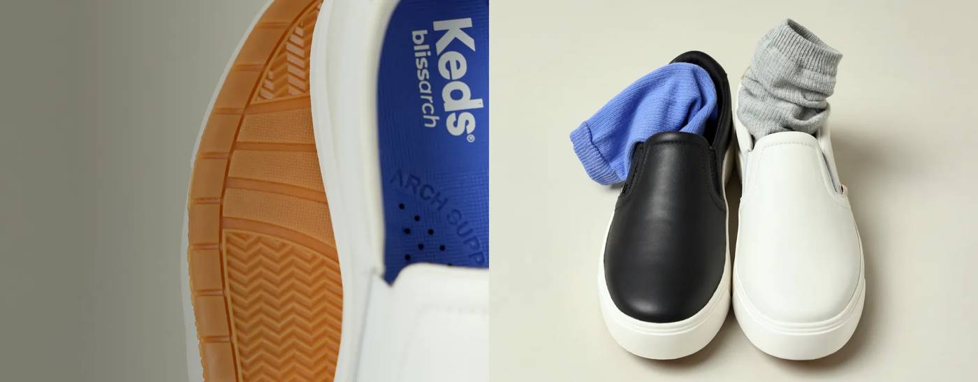 A front view of the new Park Slip-On Leather, one in black and one in white with socks tucked in.