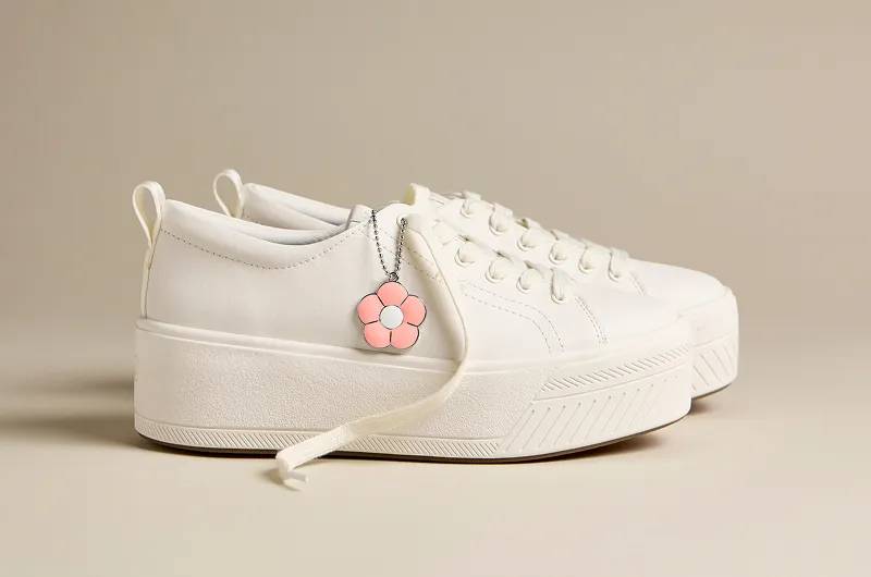 A side view of the Skyler Leather Daisy Charm Lace-Up in snow white.