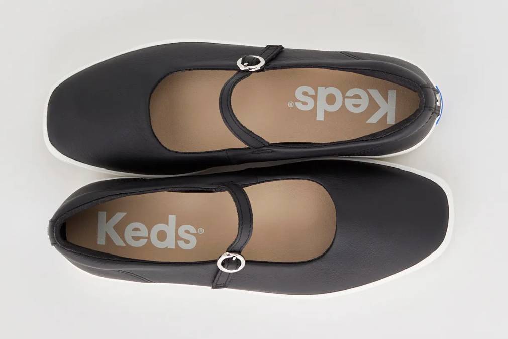 A pair of the Square Toe Mary Janes in black facing opposite directions.