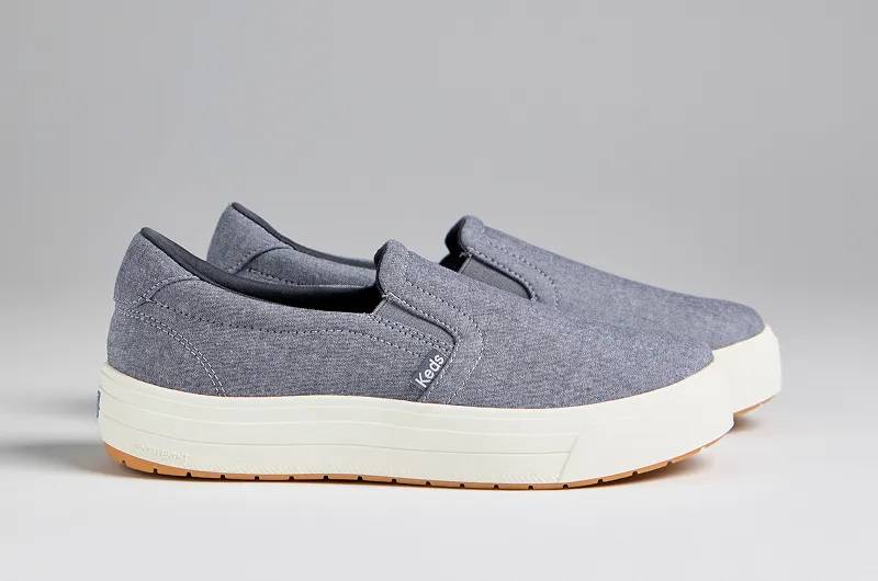 A side view of a pair of Park Chambray Platform Slip-Ons in blue. Shop Slip-Ons.