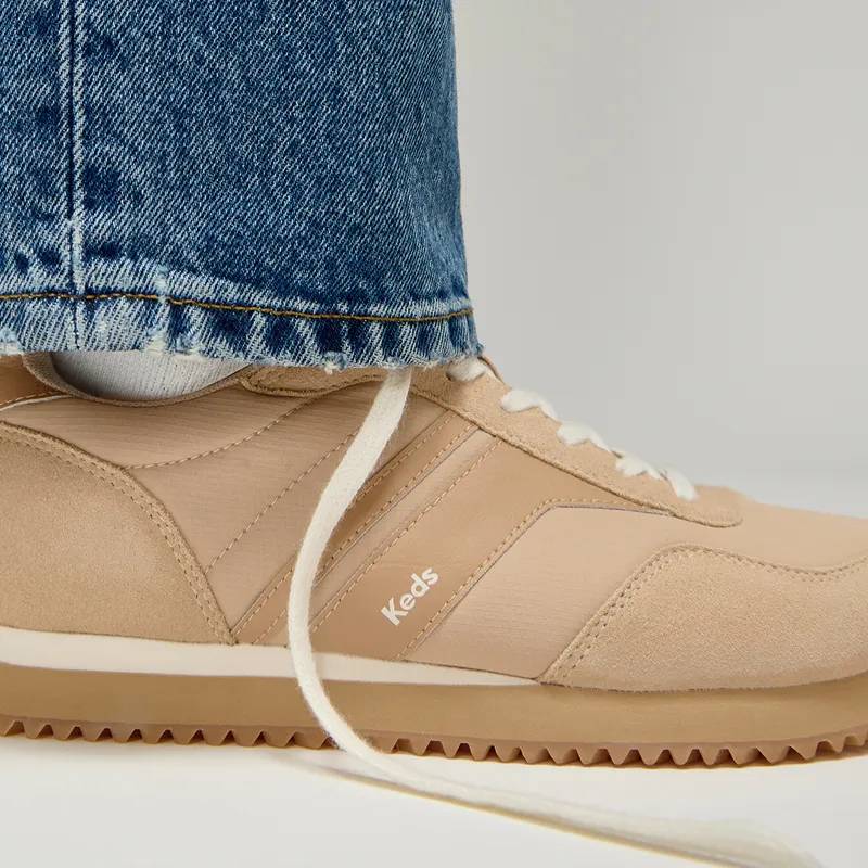 The Rena Nylon/Leather Lace-Up in Cuban sand/tan shown on foot paired with classic straight-leg jeans.