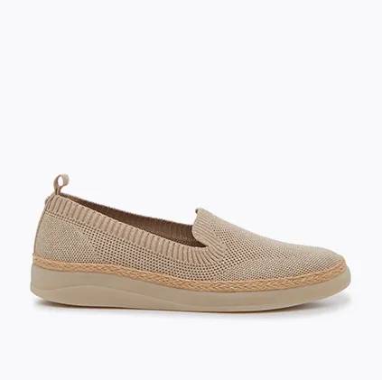 a side view of a bisque women's pally slip-on