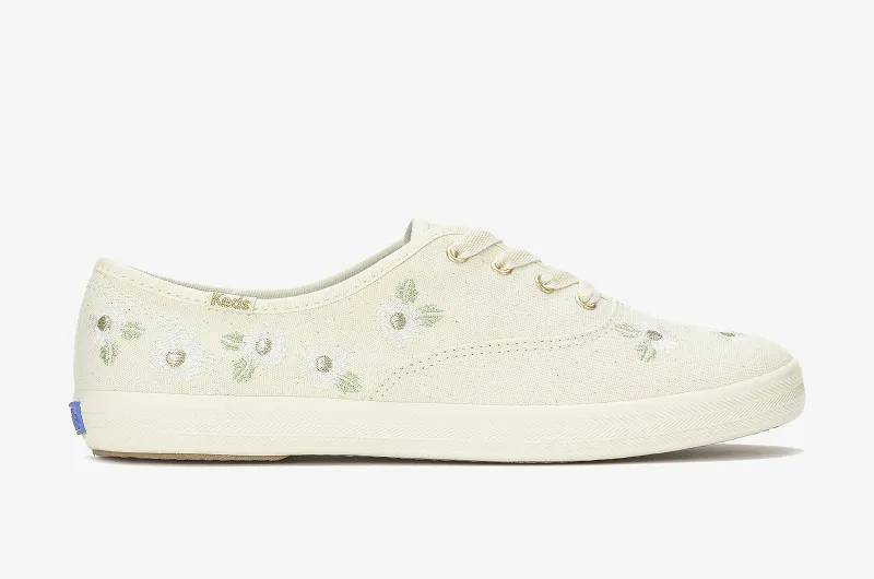A side view of the Keds Champion Canvas Floral Embroidery Lace-Up in egret.