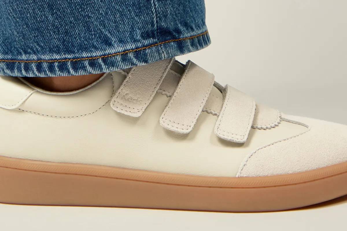 A closeup side view of the new Ace V Leather/Suede Translucent Midsole sneaker shown on foot paired with classic denim jeans. The closeup view showcases the sneaker’s triple Velcro strap design and rich texture. New Triple Threat. Shop Ace V.