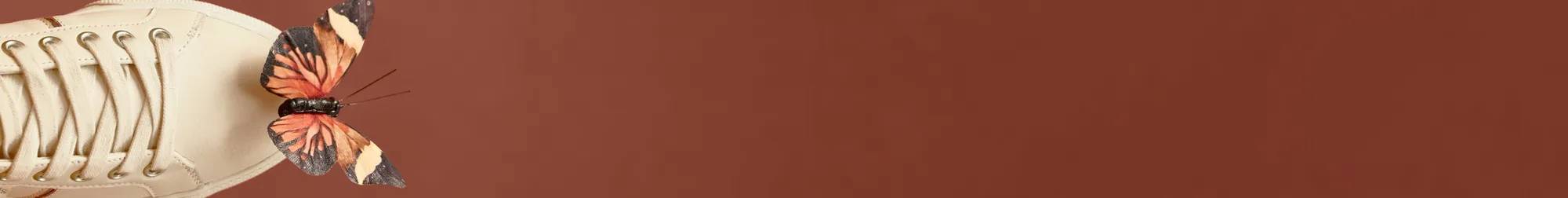 A pair of Jump Kick Duo Leather Lace-Ups in parchment shown against a warm brown background. A butterfly is shown sitting on the sneaker. Text above the sneaker says New Styles JUST Added All Sale Styles Now 35% Off! Shop Now. Prices as marked. See details.