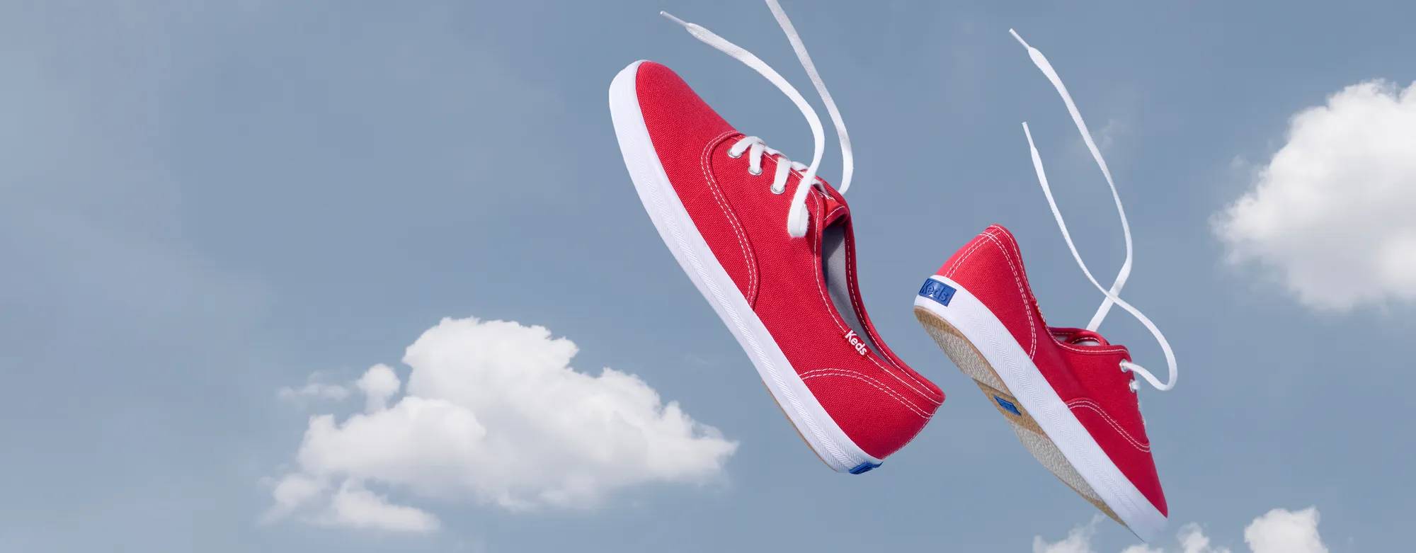 A pair of Keds Champion Canvas Lace-Ups in white floating in front of a background of a blue sky and puffy white clouds. Text above the sneakers says 30% Off Sitewide! Even the Original Keds Champion. Use code: SAVE30. Shop Now. Shop Keds Champion.