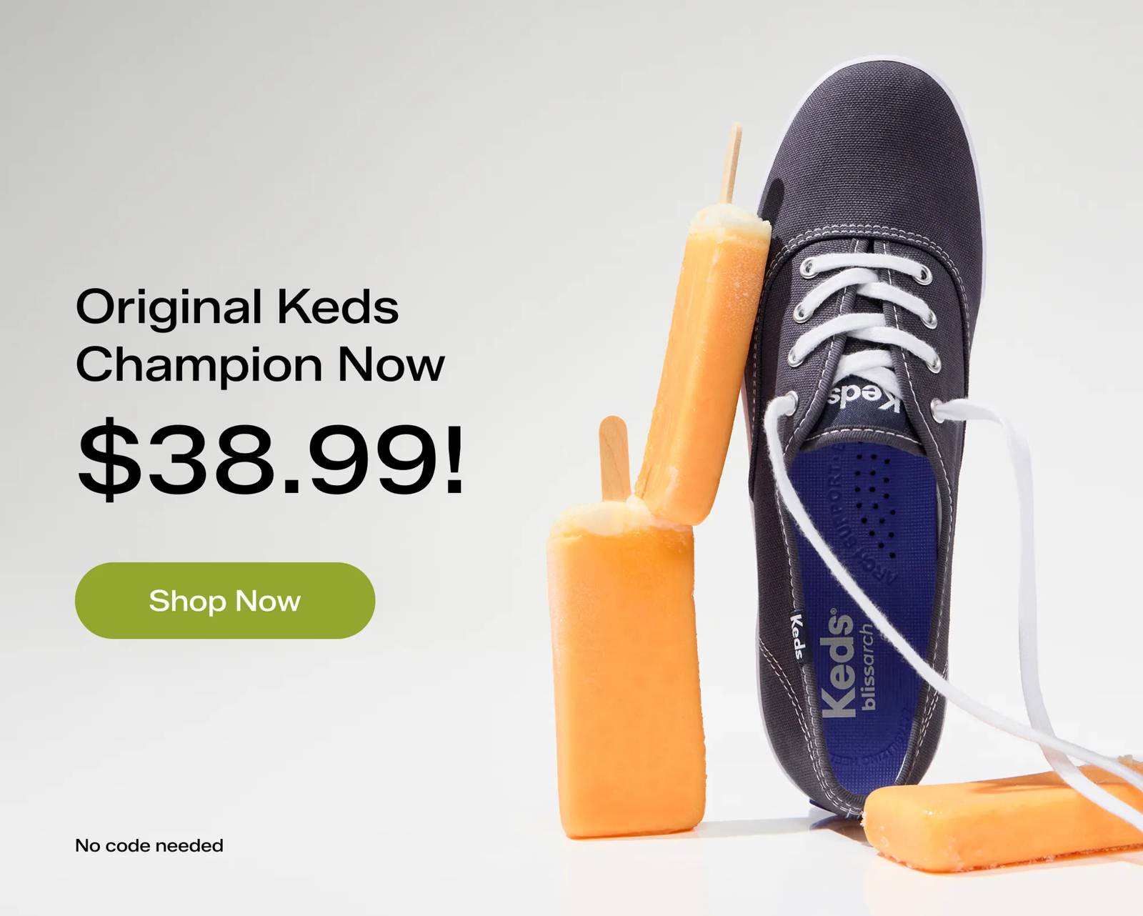The Keds Champion Originals Lace-Up in navy upright on its heel surrounded by creamsicles. The text says Original Keds Champion Now $38.99! No code needed. Shop Now