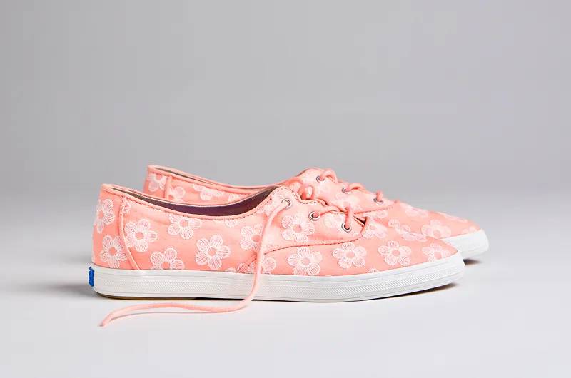 A side view of the Keds Champion Point Low Wave Canvas Floral Embroidery Lace-Up in neon coral/snow white.