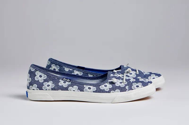 A sideview of the Rillax Champ Mini Chambray Floral Embroidery Slip-Ons in light blue. Shop Slip-Ons.