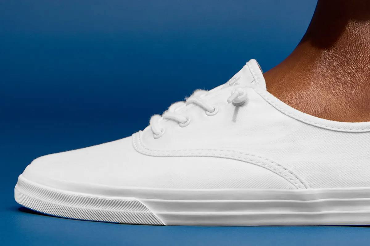 A sideview of the Rillax Champ Washed Twill Slip-On in show white shown on foot.