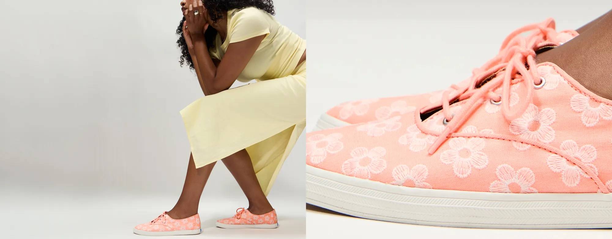 A woman wearing the Keds Champion Point Low Wave Canvas Floral Embroidery Lace-Ups in neon coral/snow white paired with a muted yellow T-shirt and matching midi skirt. Corresponding text says The Summer Shop is Open. Shop Now.