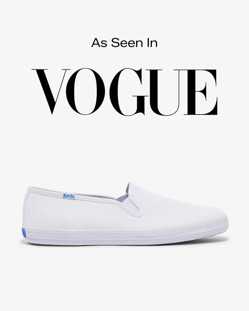 Text that says As Seen In sits above the VOGUE logo. Below is a product image of the Keds Champion Canvas Slip‑On sneaker in white. Text below reads Keds Champion Slip‑On. The skater sneaker making a comeback. Shop Now.