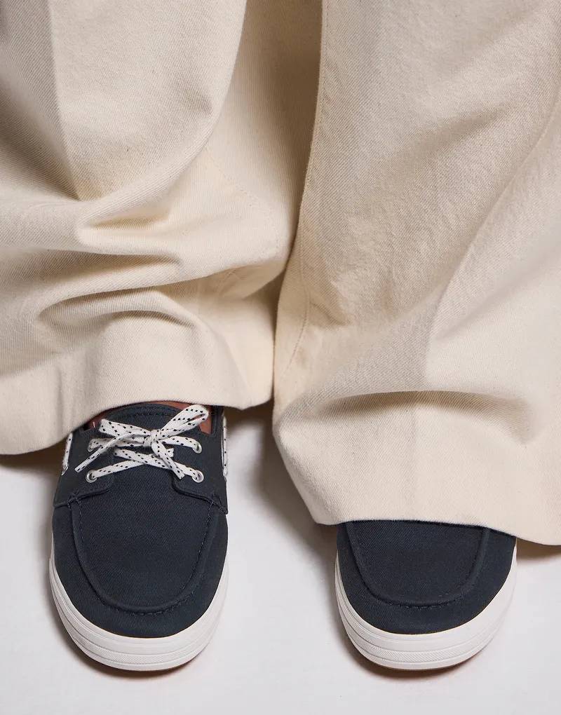 An overhead view of the Center III Boat Twill Slip-On in navy blazer paired with wide-leg tan pants.