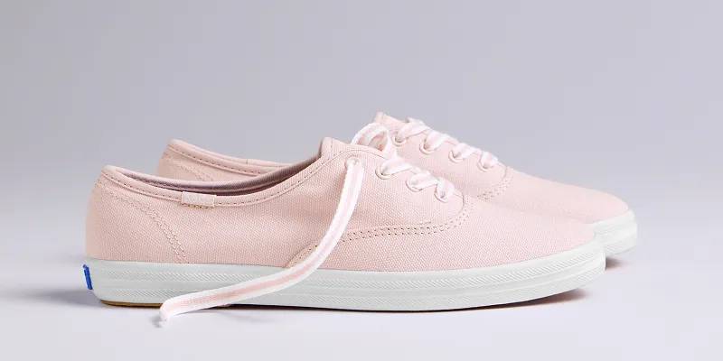 A side view of the Keds Champion Canvas Lace-Up in petal pink.