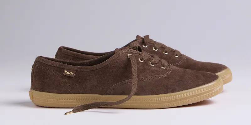 A side view of the Keds Champion Luxe Suede Lace-Up in chocolate.