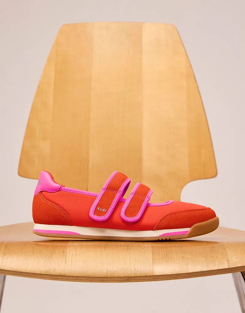 A side view of the Revival Nylon/Suede Mary Jane in red/fuchsia set on a modern wooden chair.