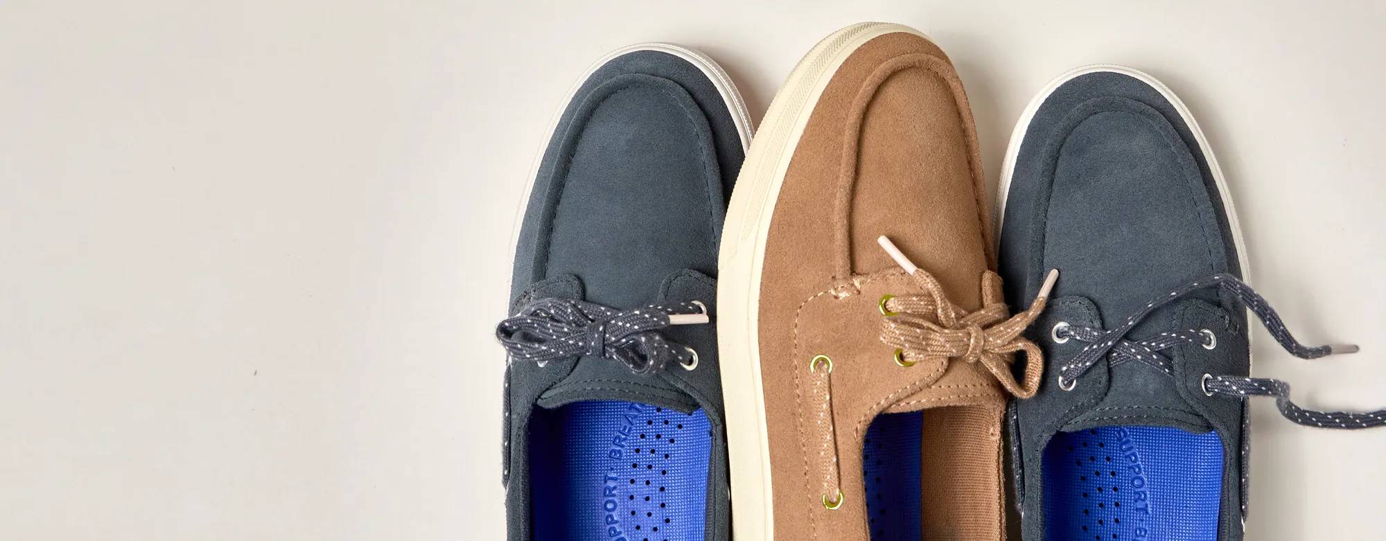 A top-down view of the two new Center III Suede Boat Shoe colors: grey and tan. Text on the image says New Colors on Deck. Shop Center Boat. See What’s New.