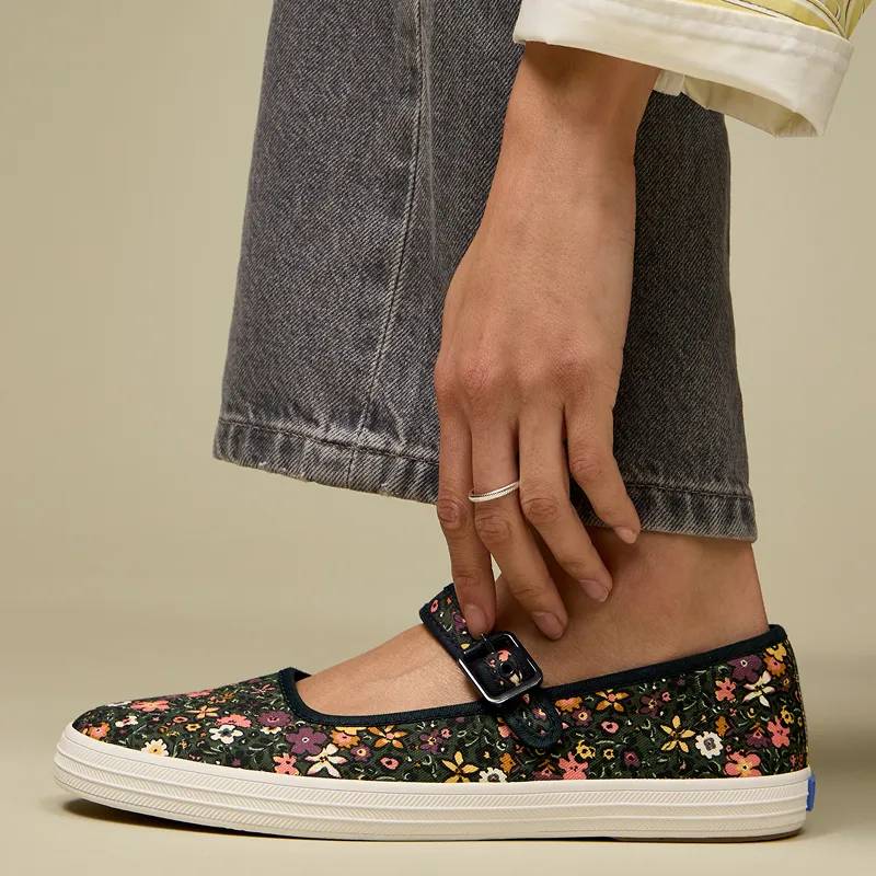 A closeup on the Maisie Mary Jane in a floral pattern. Corresponding text says Floral Romance Mary Jane meets moody florals. Shop Maisie Mary Jane.