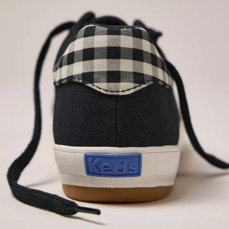 A closeup on the buffalo plaid heel of the Center III Twill Lace-Up in black/parchment. Corresponding text says Check it Out. Perfectly pairable plaid. Shop Plaid.