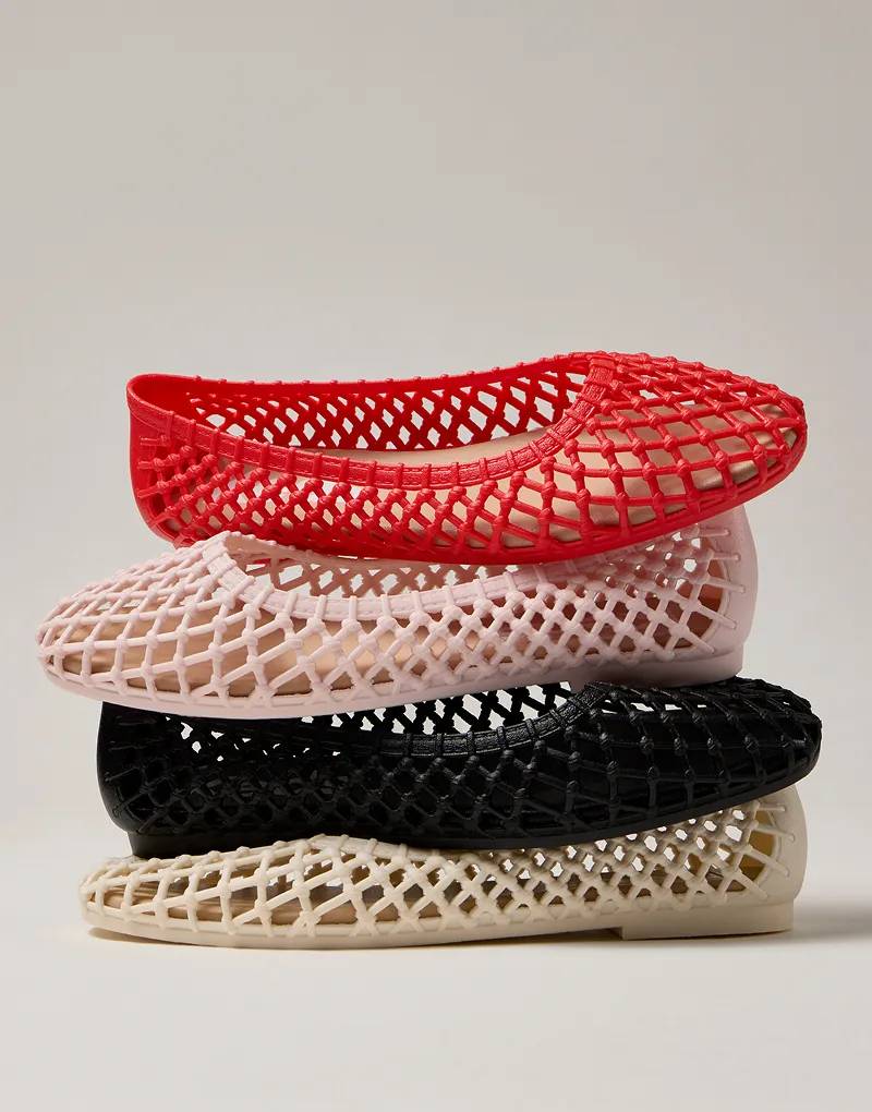 A stack of four colors of Jelly Shoes—cream, black, bloom, and red—against an off-white background.