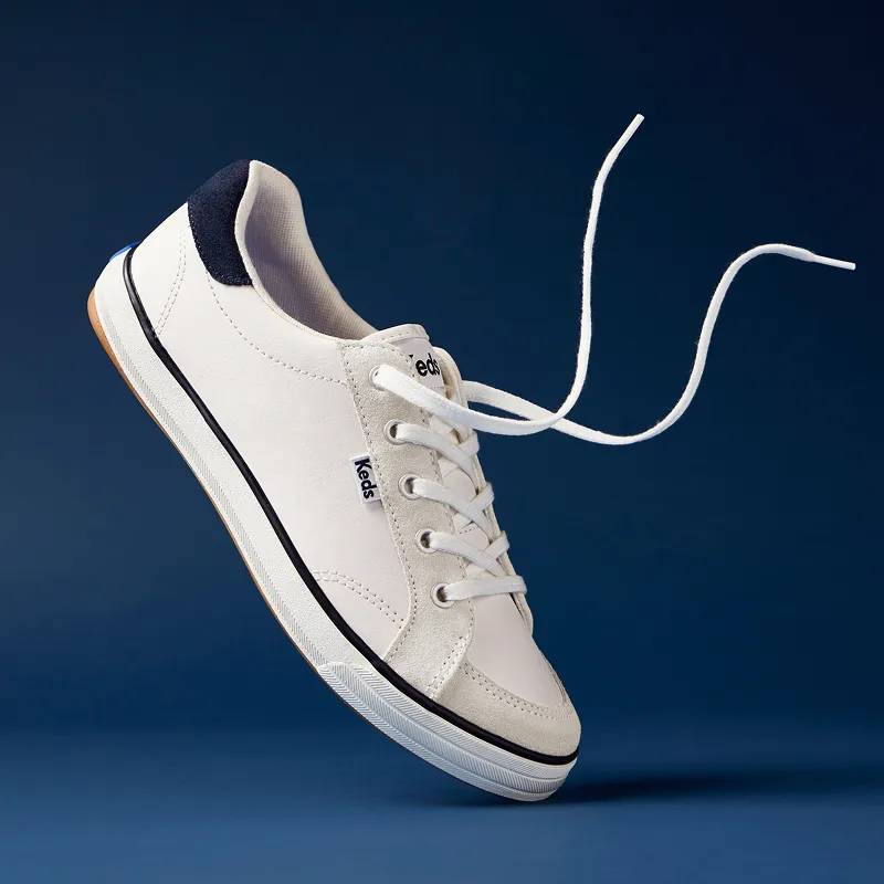 A blue background with an angled view of the Center III Leather/Suede Lace-Up in snow white/navy with the laces untied.
