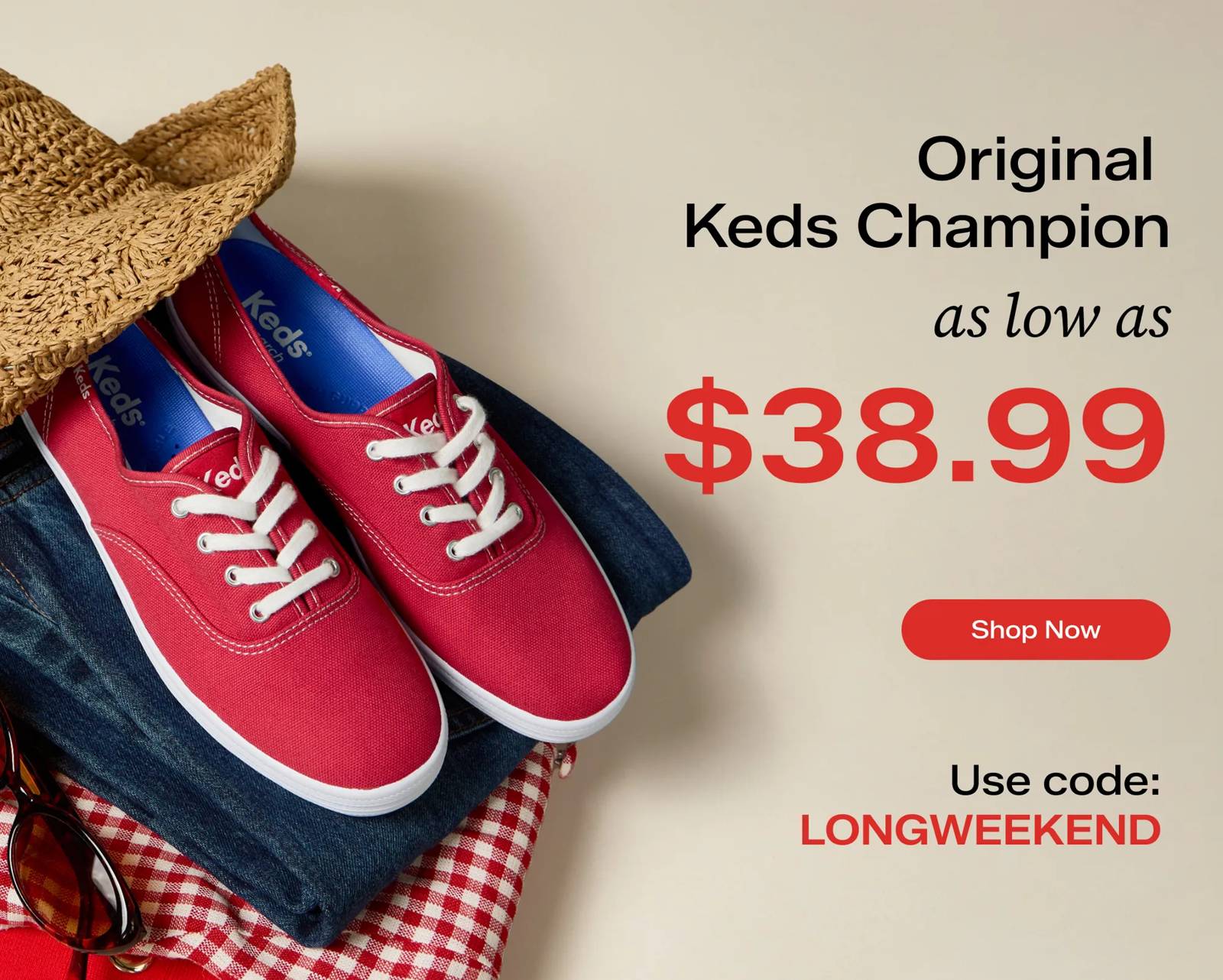 Text on a beige background says Original Keds Champion as low as $38.99 with code LONGWEEKEND. Shop now. To the left of the text, a pair of Original Keds Champion Canvas Lace-Ups in red are sitting on top of a stack of folded clothing: a red sweater, a red-and-white gingham top and dark wash jeans. A pair of sunglasses and a woven hemp bucket hat are also balanced on the stack.