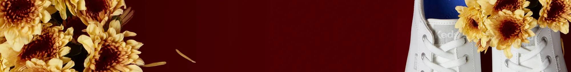 A burgundy banner with white text says 35% Off Fri-Yay Flash Sale! Use code: TODAYONLY. Select styles only. To the left of the text is a closeup of a bouquet of muted yellow mums. To the right of the text is a zoomed-in top-down view of a pair of Center III Leather Lace-Ups in white. The sneaker on the right has a bouquet of muted yellow mums tucked into it.