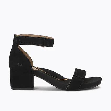 A side view of a black womens tari sandal