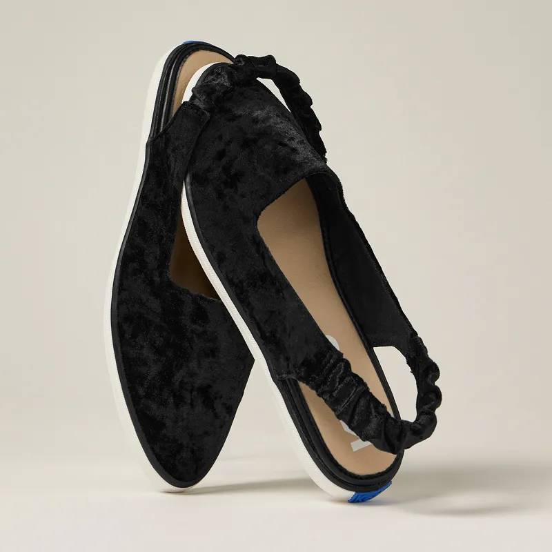 A pair of the Point Toe Crushed Velvet Slingbacks in black with the scrunchy slingback strap around the toe of the other.