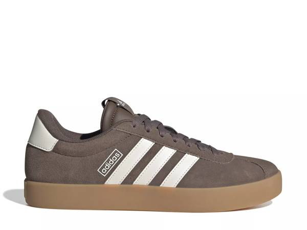 Featuring a brown Adidas court sneaker.