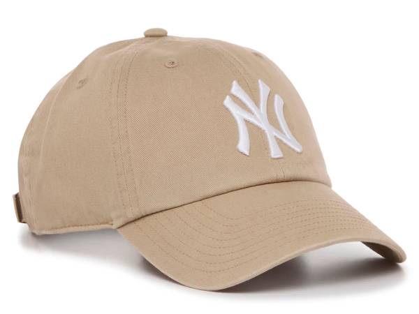 Featuring a khaki New York Yankees baseball cap.