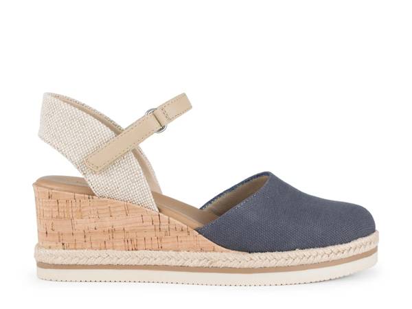 Featuring a blue and beige wedge sandal.