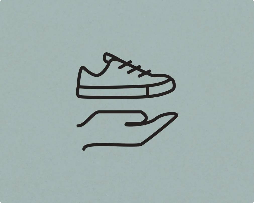 Simple icon a shoe on top of a hand