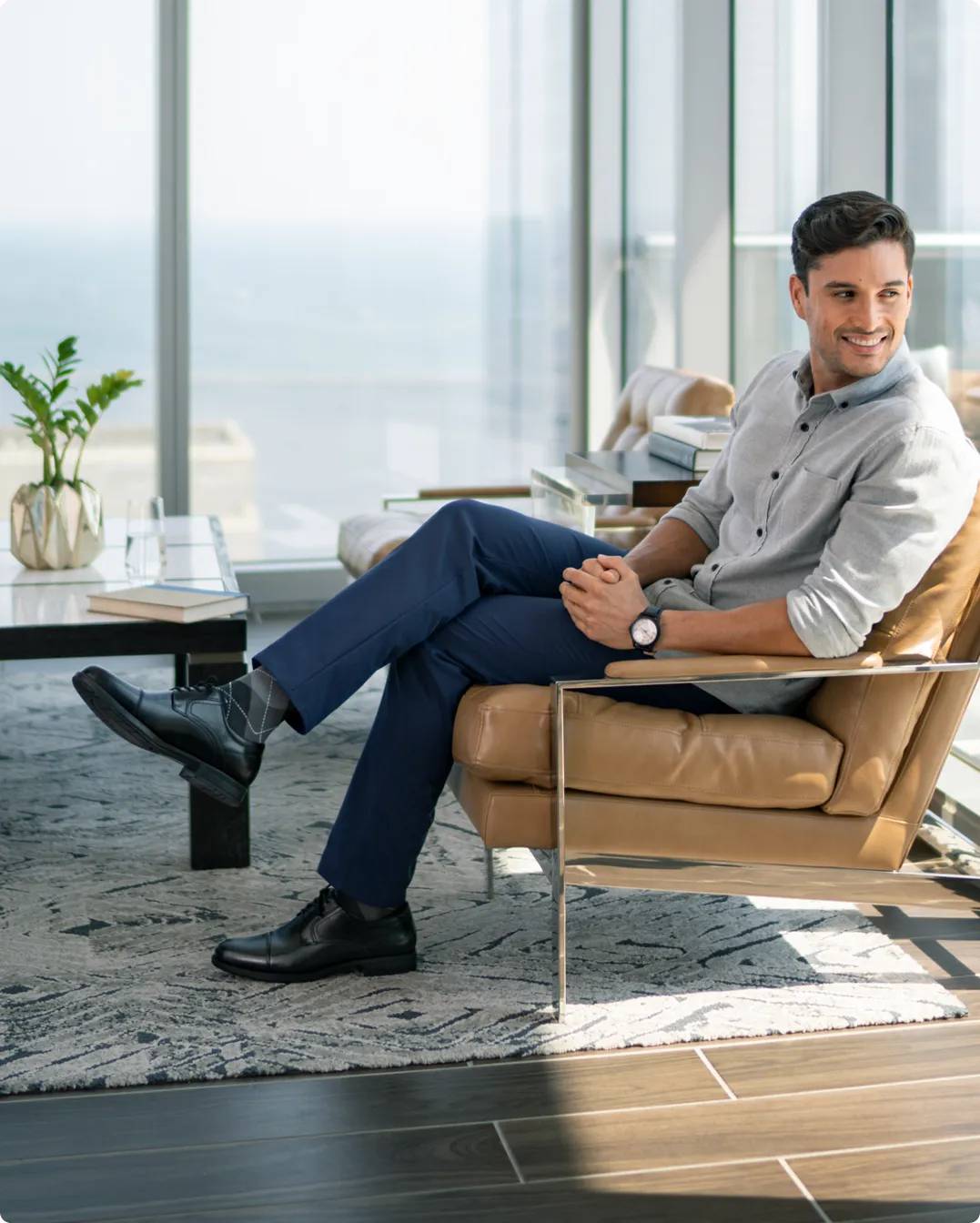 Man sitting on chair wearing black dress shoes