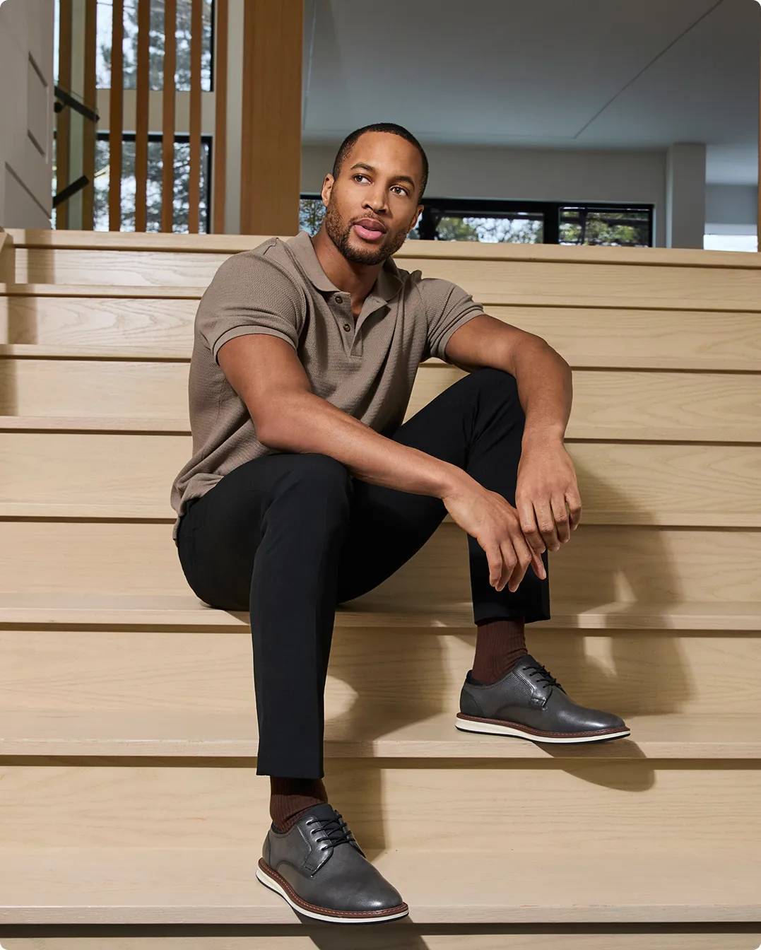 Man sitting down wearing black dress shoes